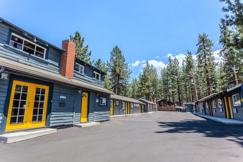 Exterior of Tahoe Mountain Inn with pine trees in South Lake Tahoe
