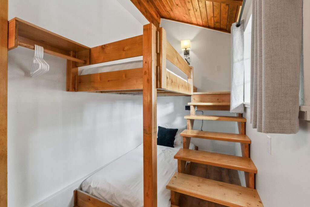 XL twin bunk beds with a wooden ladder in Room 24 at Tahoe Mountain Inn