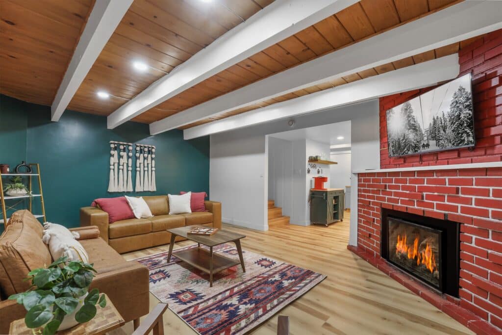 Cabin family room with lit fireplace and seating